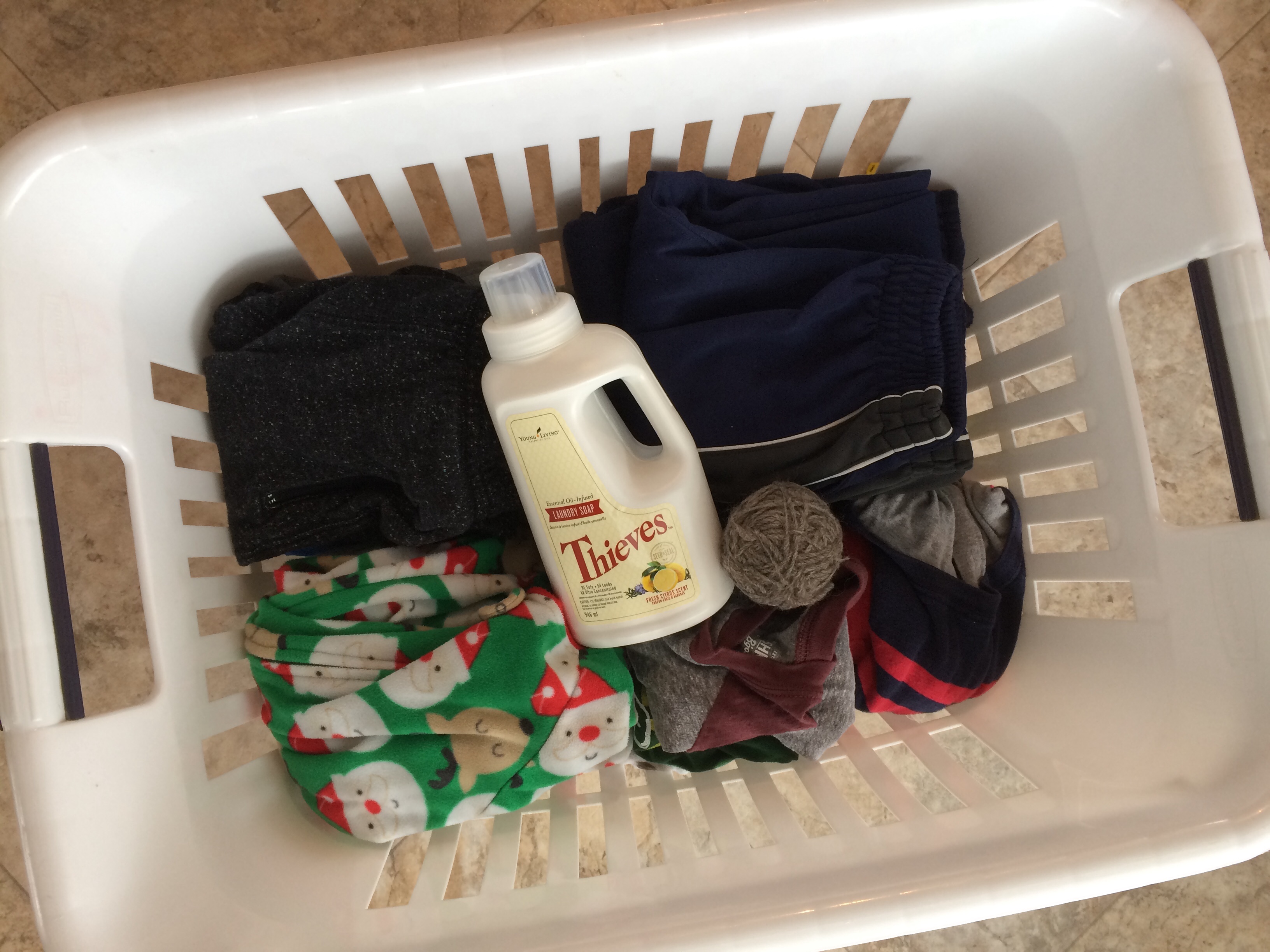 Thieves Laundry Soap in a laundry basket with clothes that have been in storage for 5+ years and still smell like fragrance detergent.