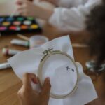 diverse children doing embroidery and painting