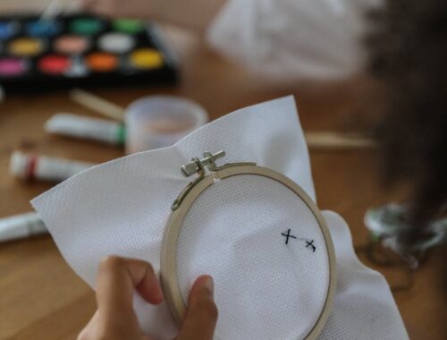 diverse children doing embroidery and painting