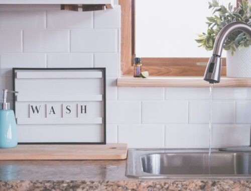 faucet with water and soap in bathroom with wash inscription