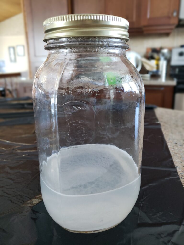 Lye and water mixed into a Mason jar