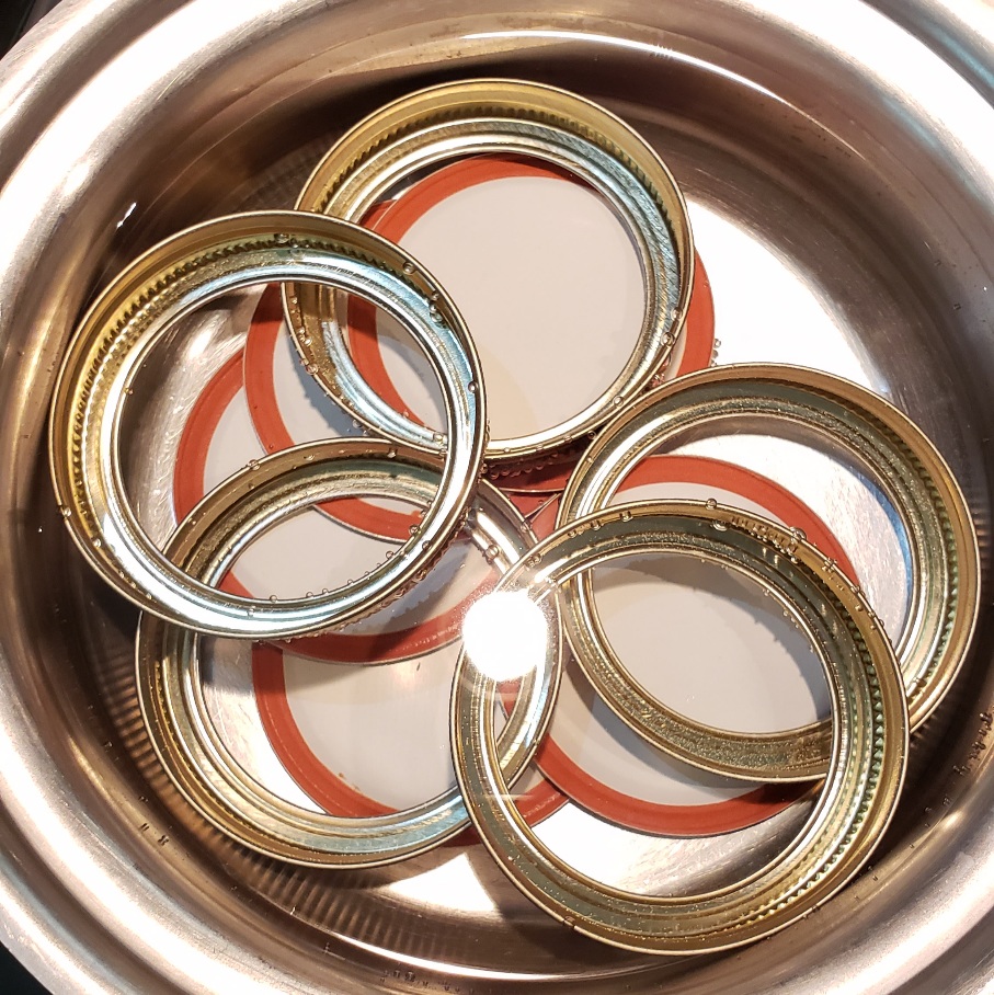 Canning lids in warm water for canning