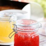 jar with red jam on white sauer