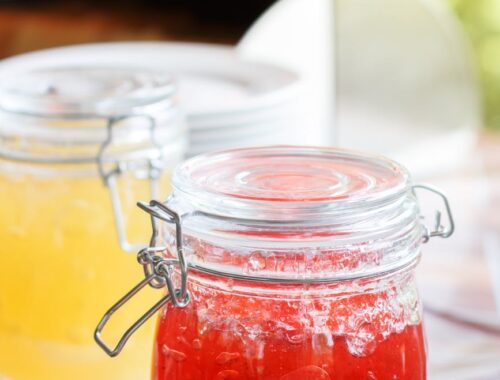 jar with red jam on white sauer